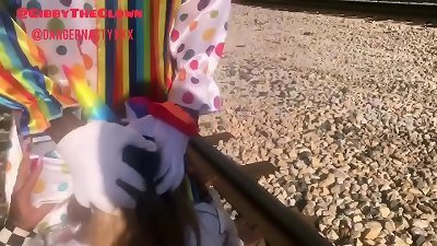 Clown nearly gets beat by train while getting head