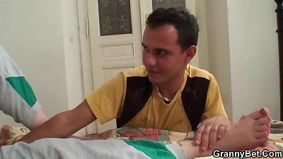 Injured old grandmother getting healed by young man sausage